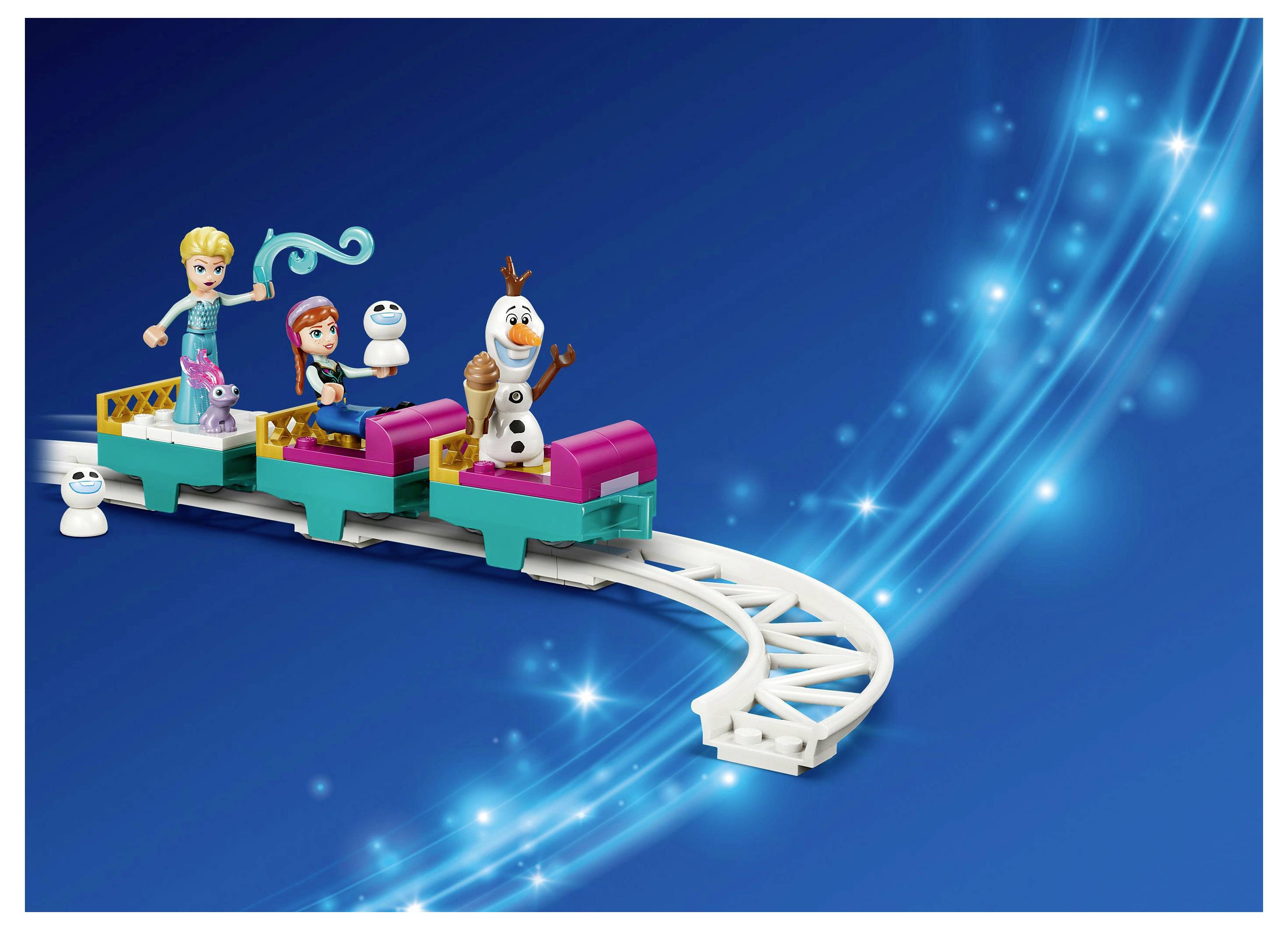 Spielzeugzug auf Schienen mit Figuren, die einem Schneemann ähneln, vor einem blauen, glitzernden Hintergrund.