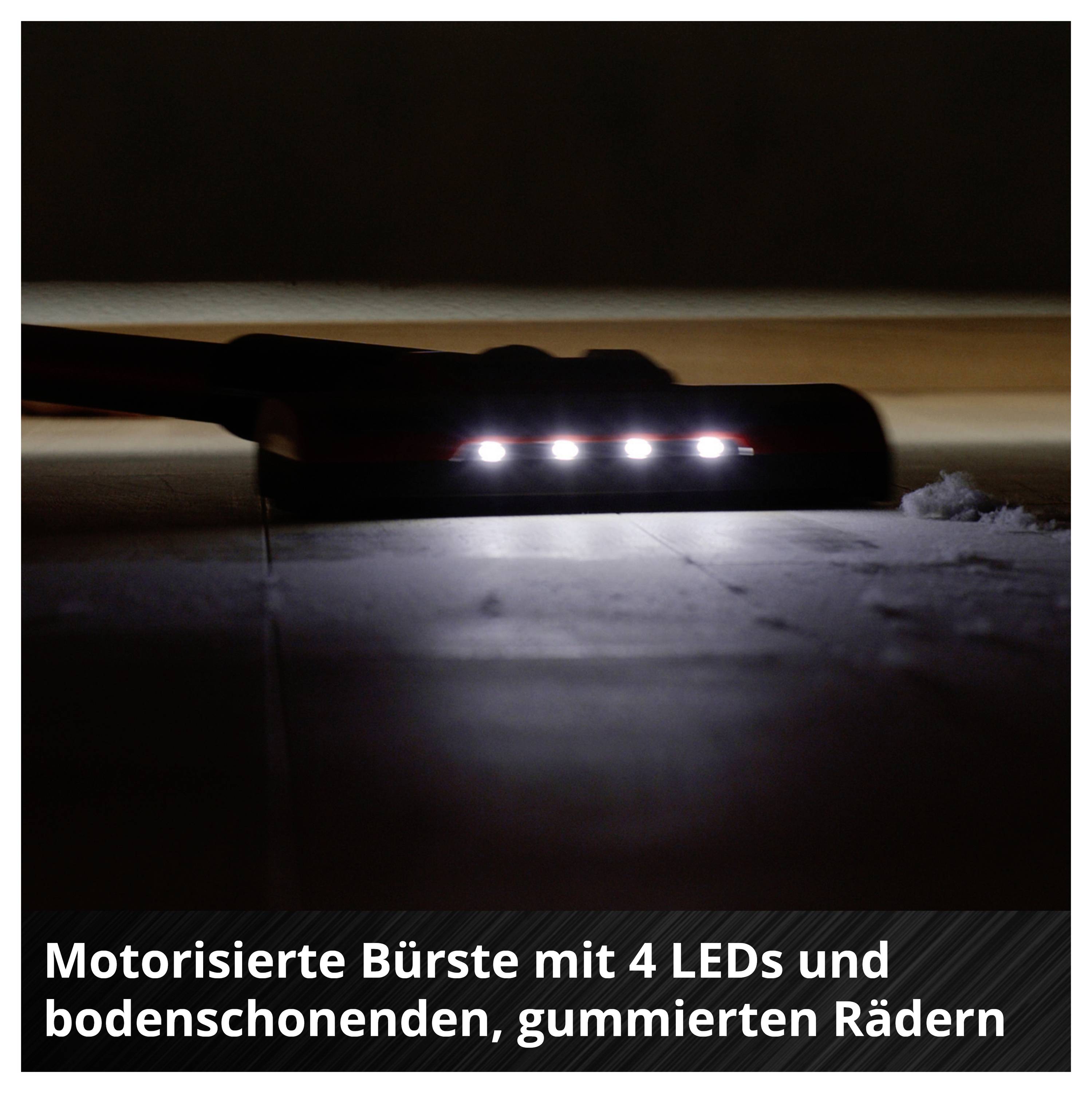 Motorisierte Bürste mit 4 LEDs und gummierten, bodenschonenden Rädern, die eine dunkle Bodenfläche beleuchtet.