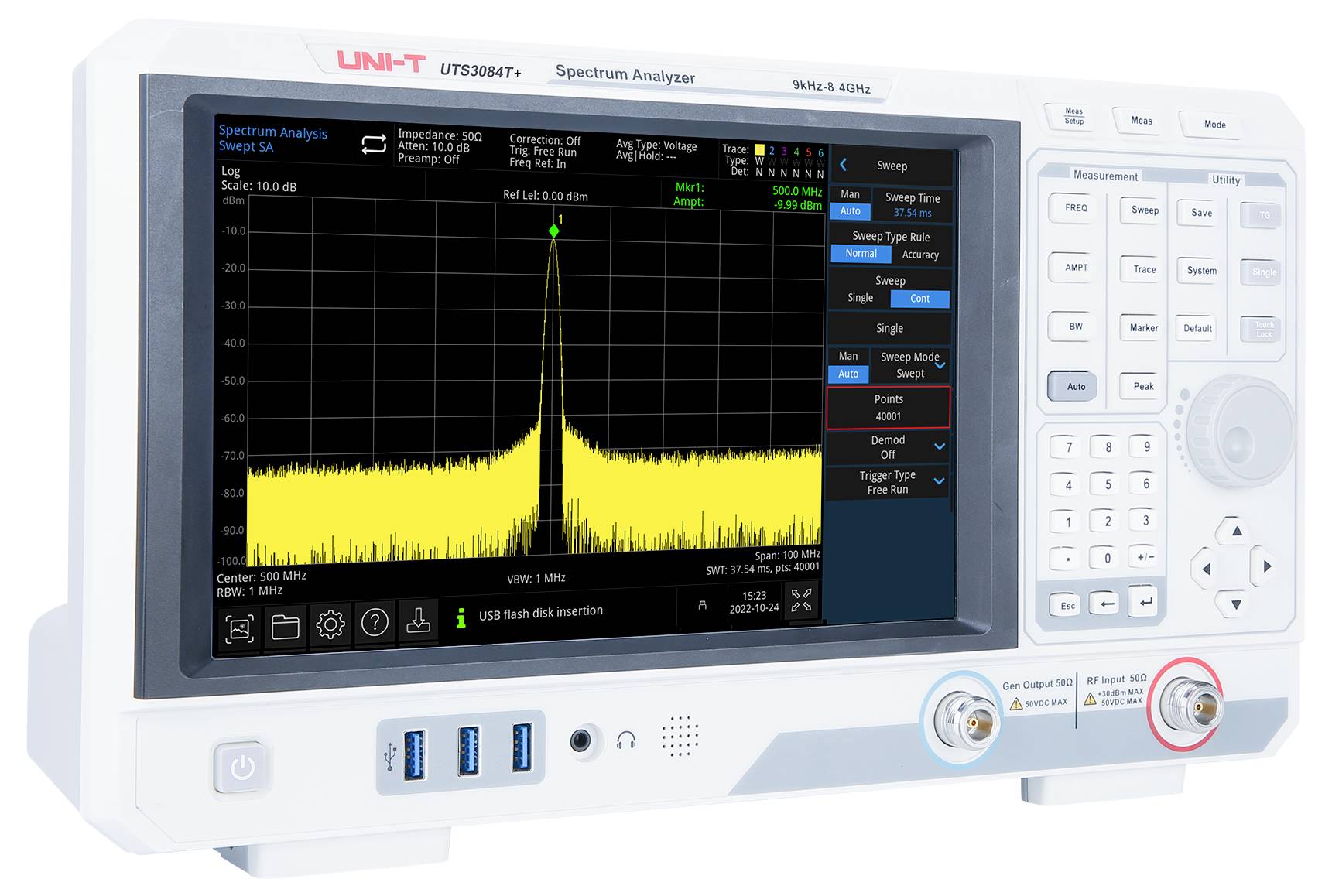 Spektrum-Analysator, der ein gelbes Frequenzdiagramm mit einem zentralen Peak zeigt. Verschiedene Einstellungen und Steuerungstasten sind am Gerät sichtbar.