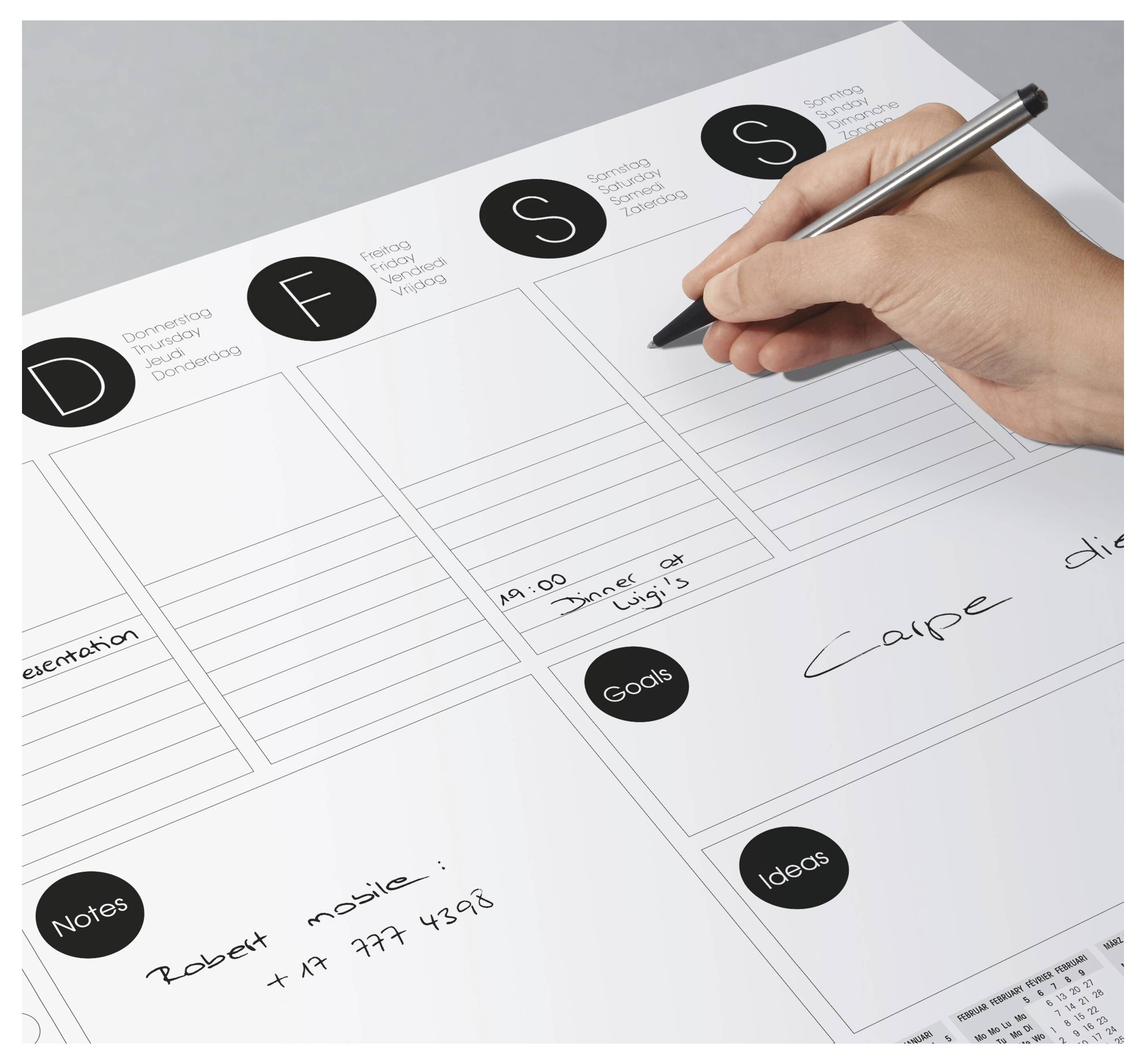 Eine Person, die auf einer Planungstafel schreibt, mit Abschnitten für 