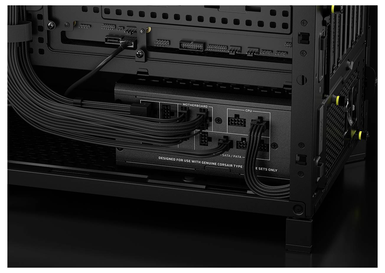 Das Innere eines Computergehäuses, das ein modulares Netzteil mit beschrifteten Anschlüssen für Mainboard, CPU, PCIe und SATA-Verbindungen zeigt.