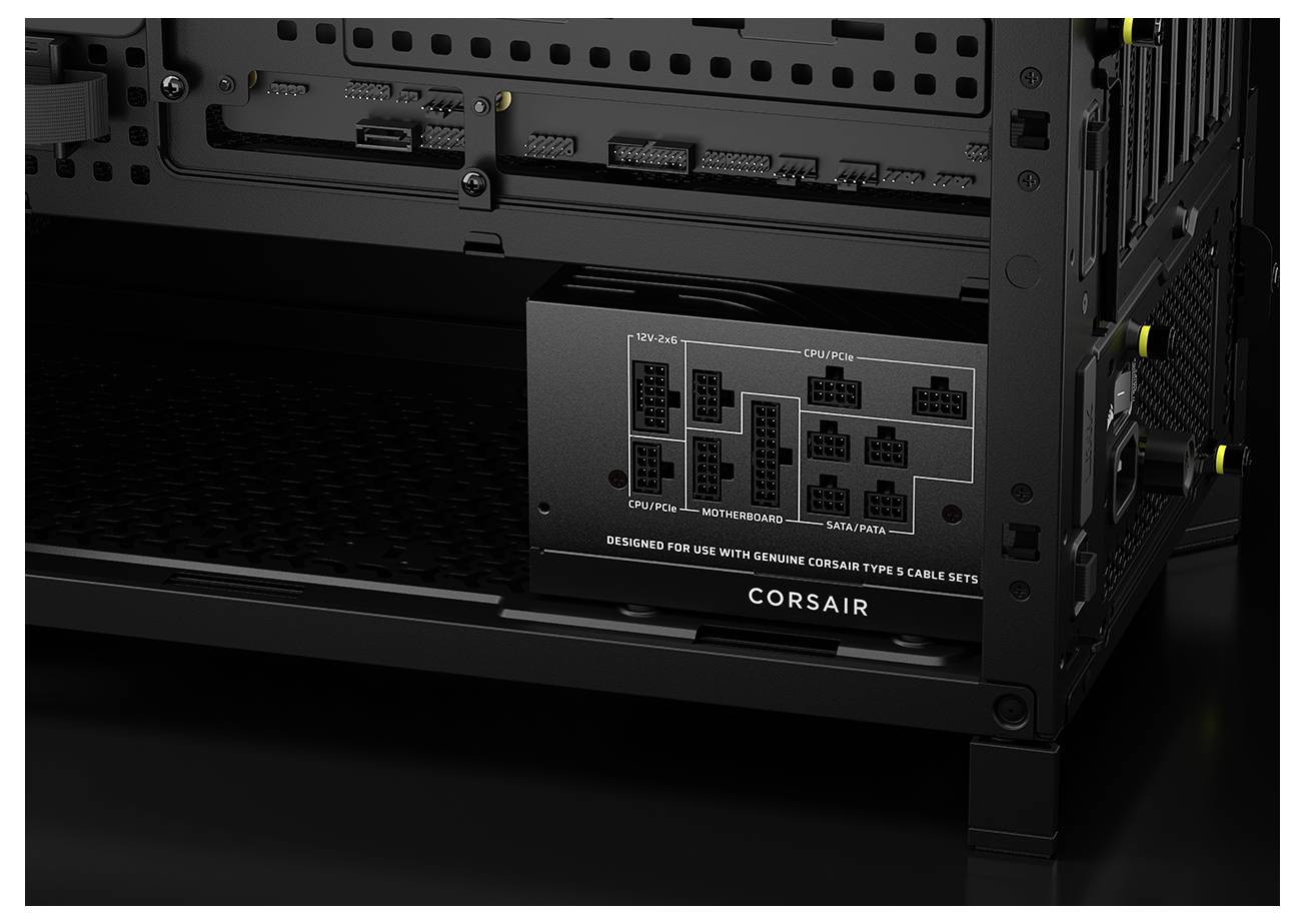 Ein schwarzes Corsair-Netzteil, das im Inneren eines Computergehäuses installiert ist und verschiedene Anschlussports für CPU, Motherboard, SATA und Peripheriegeräte zeigt.
