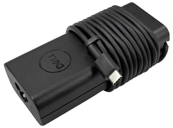 Ein schwarzes Laptop-Netzteil mit einem aufgewickelten Kabel.