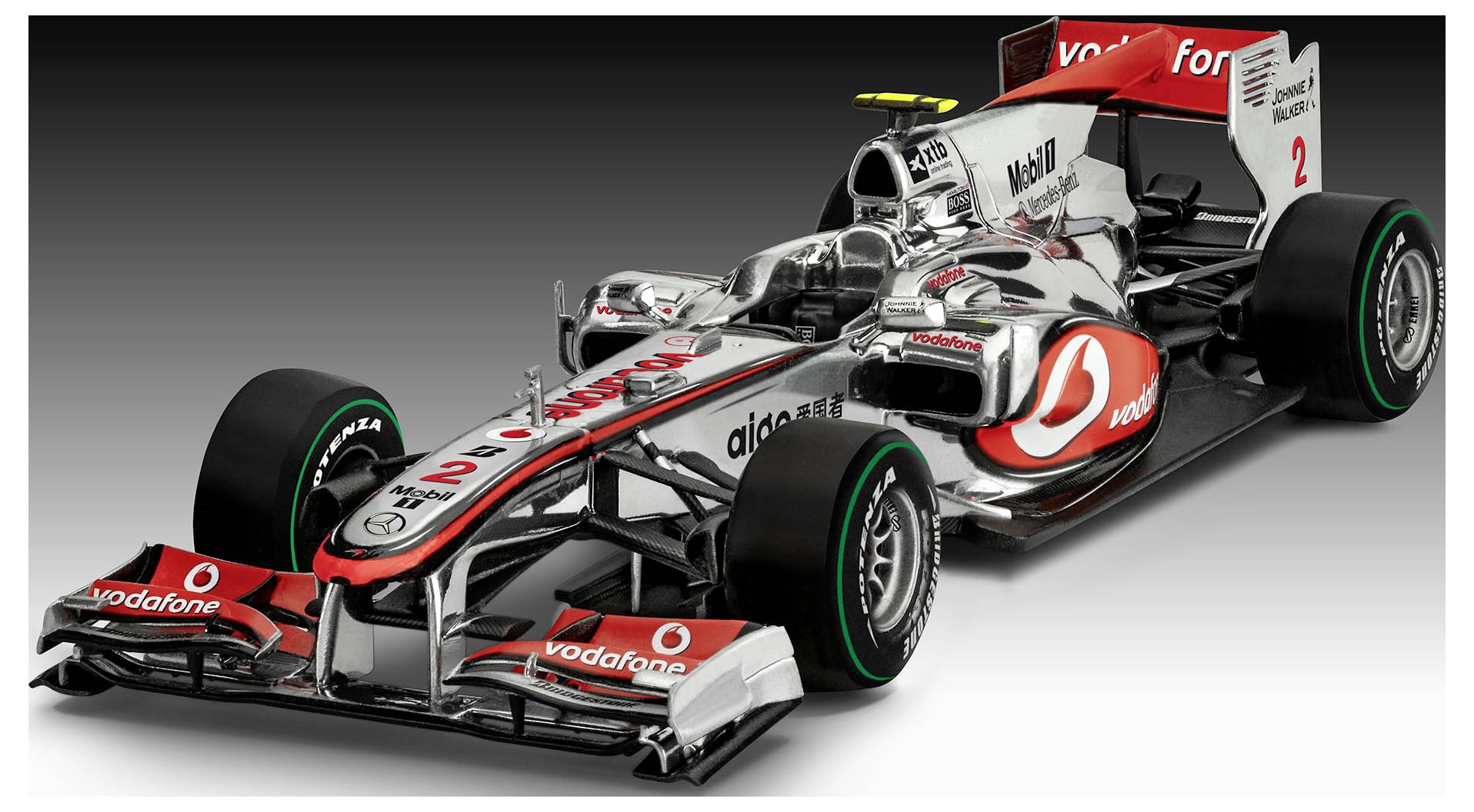 Ein schlankes Formel-1-Rennfahrzeug in rot und grau, mit der Nummer '2' auf der Motorhaube und auffälliger Vodafone-Markierung.