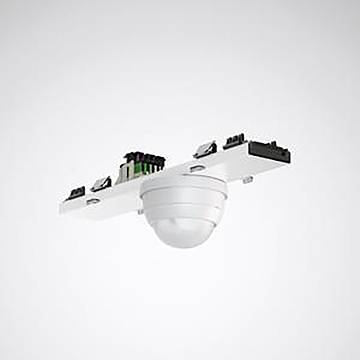 Ein weißer, an der Decke montierter Bewegungsmelder mit Kuppelform, umgeben von verschiedenen elektronischen Komponenten auf einer rechteckigen Basis.