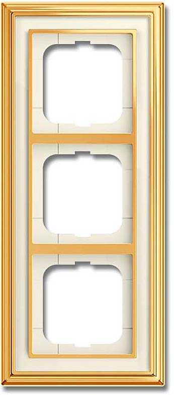 Ein dekoratives, vertikales, dreifach-Wandplattenrahmen aus goldener Farbe für Elektrosteckdosen oder Schalter.