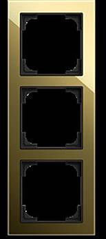 Ein vertikales, glänzendes Goldlichtschalter-Panel mit Platz für drei rechteckige Schalter, shown against a black background.