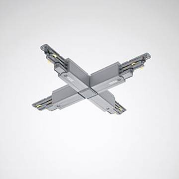 Ein grauer, kreuzförmiger Metallverbinder mit sichtbaren Steckern an jedem Ende, vor einem schlichten Hintergrund angebracht.