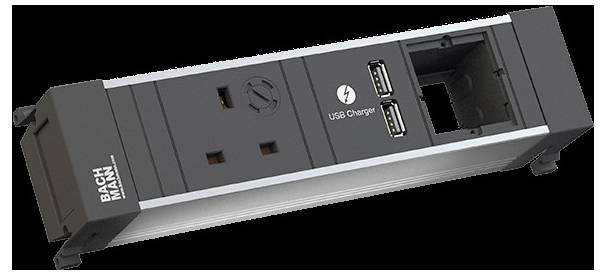 Bachmann-Strommodul mit zwei USB-Anschlüssen und einer Standard-Steckdose, konzipiert für die Tischinstallation.