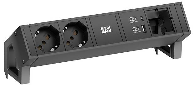 BACHMANN-Steckdosenleiste mit zwei europäischen Steckdosen, einer Universalsteckdose und zwei USB-Anschlüssen zum Aufladen, alle auf einem schwarzen Ständer montiert.