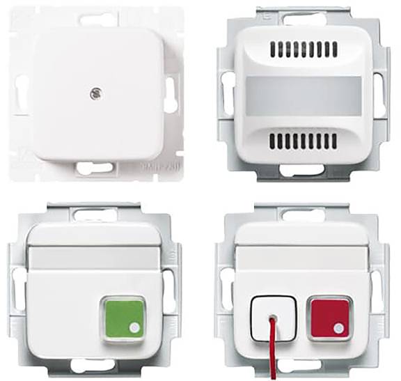 Vier elektrische Schalter: einer schlicht, einer belüftet, einer mit einem grünen Knopf und einer mit einem roten Knopf und roter Schnur.