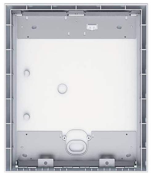 Ein weißes, rechteckiges Kunststoff-Elektrokasten mit grauem Rahmen, mit Befestigungspunkten und einer kreisförmigen Öffnung in der Mitte.