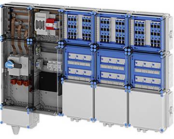 Ein elektrisches Schalttafelpult mit drei blauen Schaltermodulen, Kupferschienen und einem Leitungsschutzschalter. Die Komponenten sind ordentlich angeordnet.