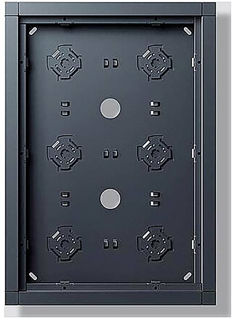 Ein schwarzes rechteckiges Bedienfeld mit einer symmetrischen Anordnung von kreisförmigen Ausschnitten und geometrischen Mustern, wahrscheinlich Teil eines elektronischen oder mechanischen Geräts.