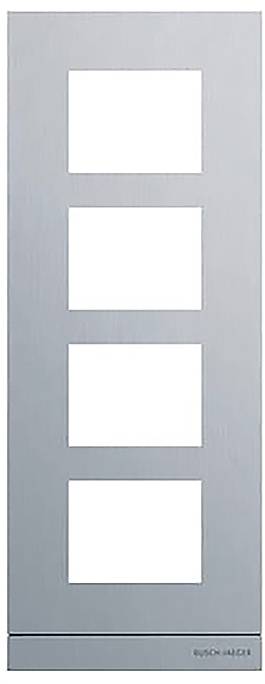 Ein rechteckiges Metallpanel mit vier quadratischen Ausschnitten, das zum Halten oder Ausstellen von Gegenständen verwendet wird. Unten rechts befindet sich schwach sichtbarer Text.