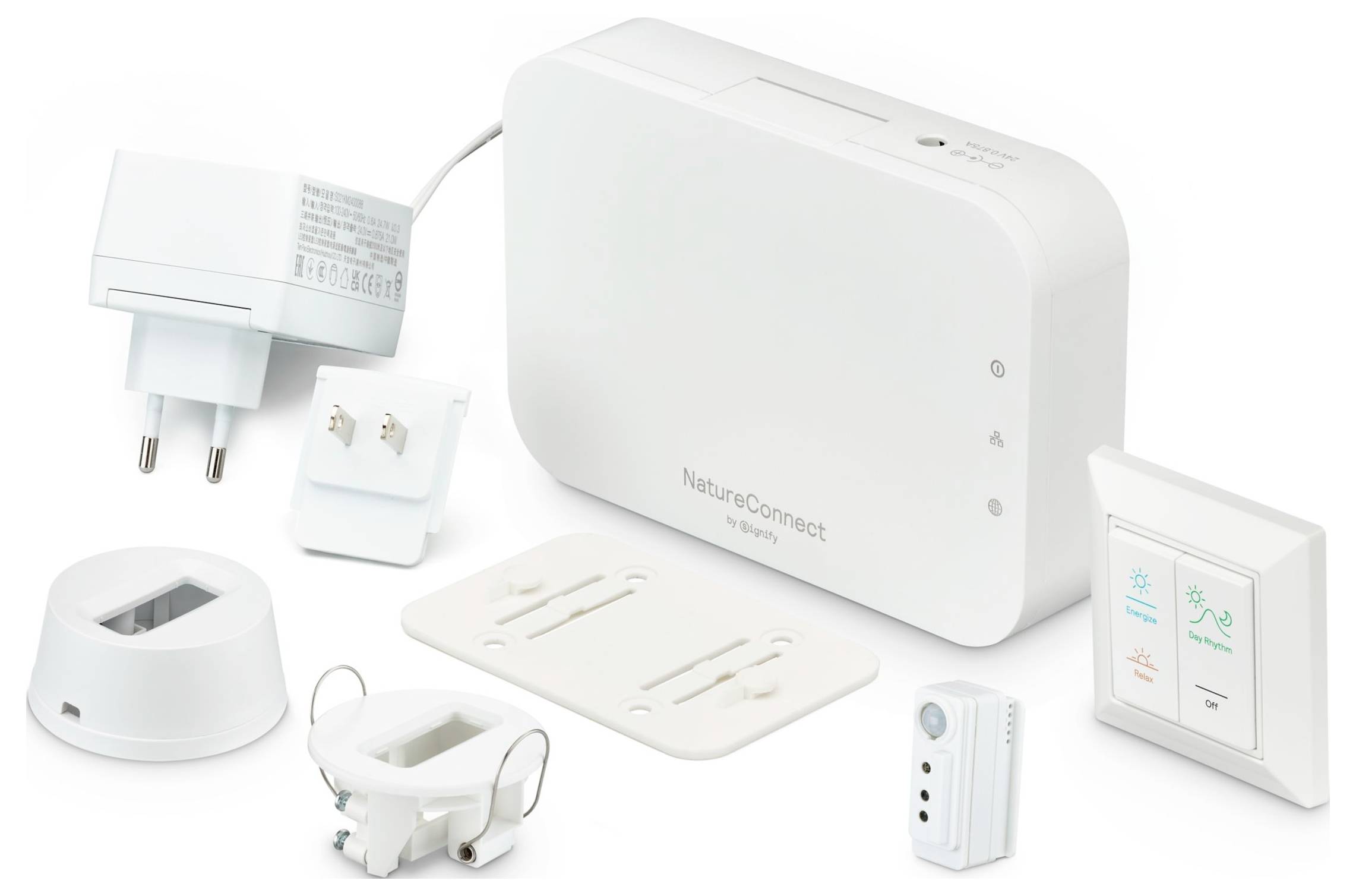 „Ein Satz elektronischer Komponenten, bestehend aus einem Netzteil, verschiedenen Steckverbindern und einem weißen Gerät mit der Bezeichnung NatureConnect von Signify.