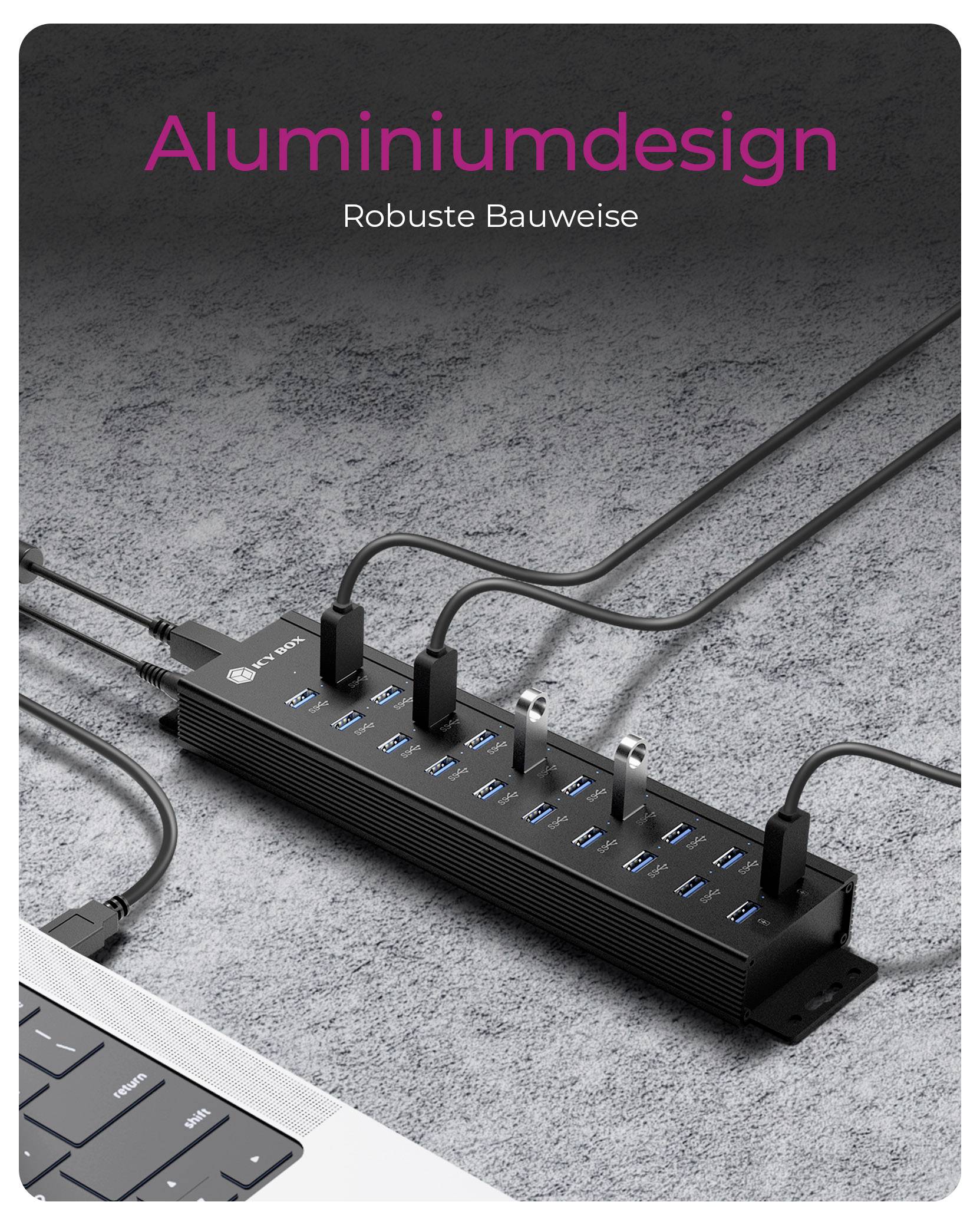 Ein schwarzer USB-Hub mit mehreren Anschlüssen, der mit Kabeln verbunden ist und auf einer grauen Oberfläche neben einem Laptop liegt. Text lautet: 'Aluminiumdesign Robuste Bauweise'.