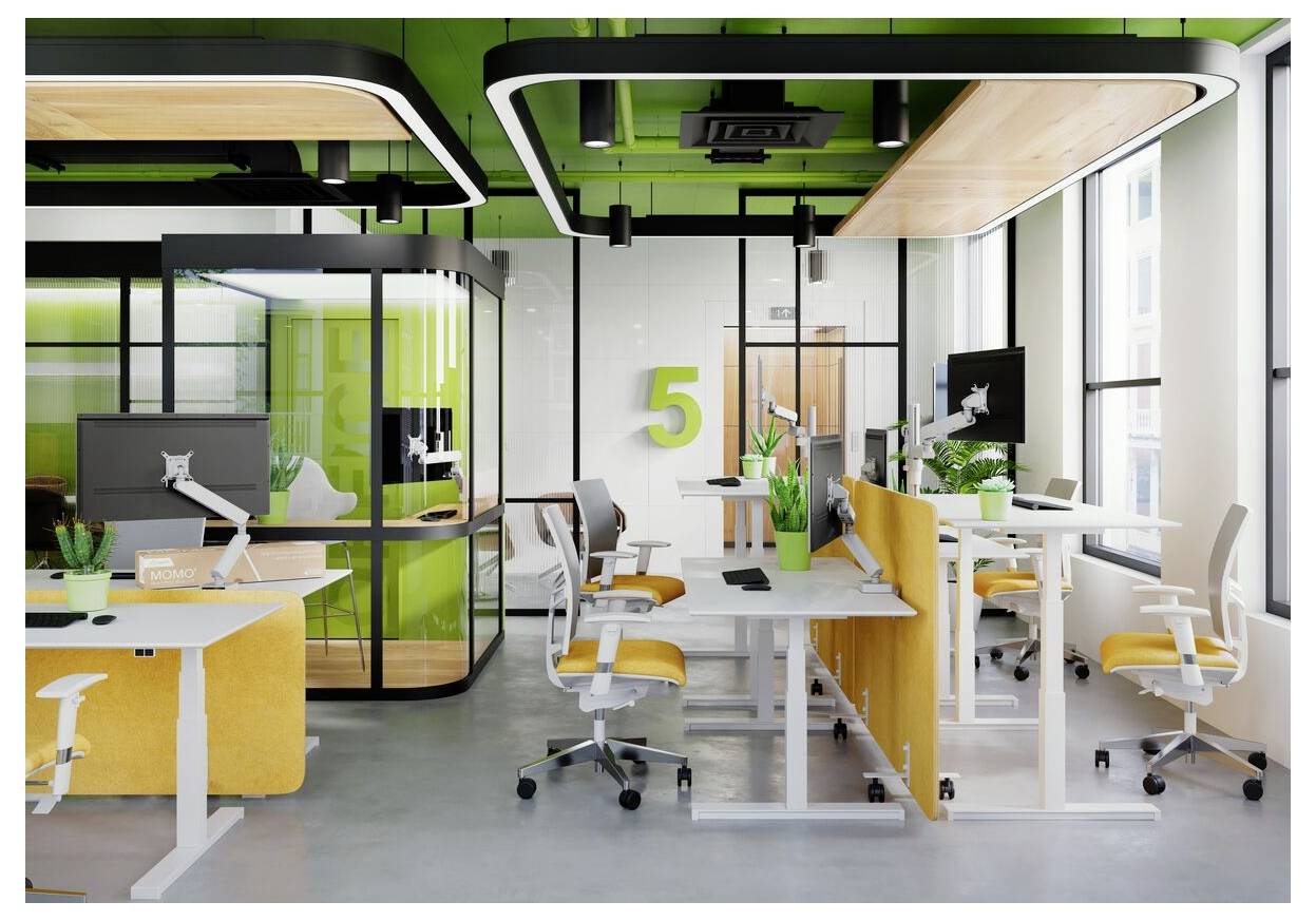 A modern, brightly lit office with green and yellow accents. Features desks, ergonomic chairs, computers, plants, and a meeting pod.