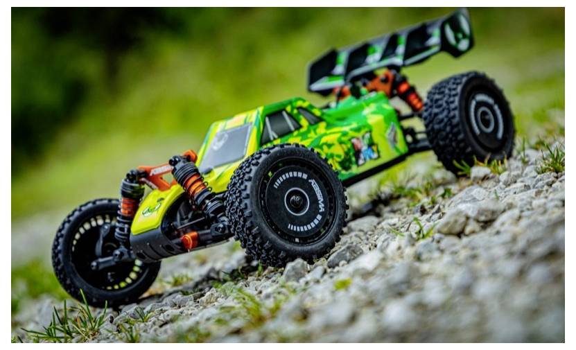 Ein lebhaftes, grünes ferngesteuertes Auto mit großen schwarzen Reifen befindet sich auf einer felsigen Außenoberfläche, leicht zum Betrachter nach rechts geneigt.