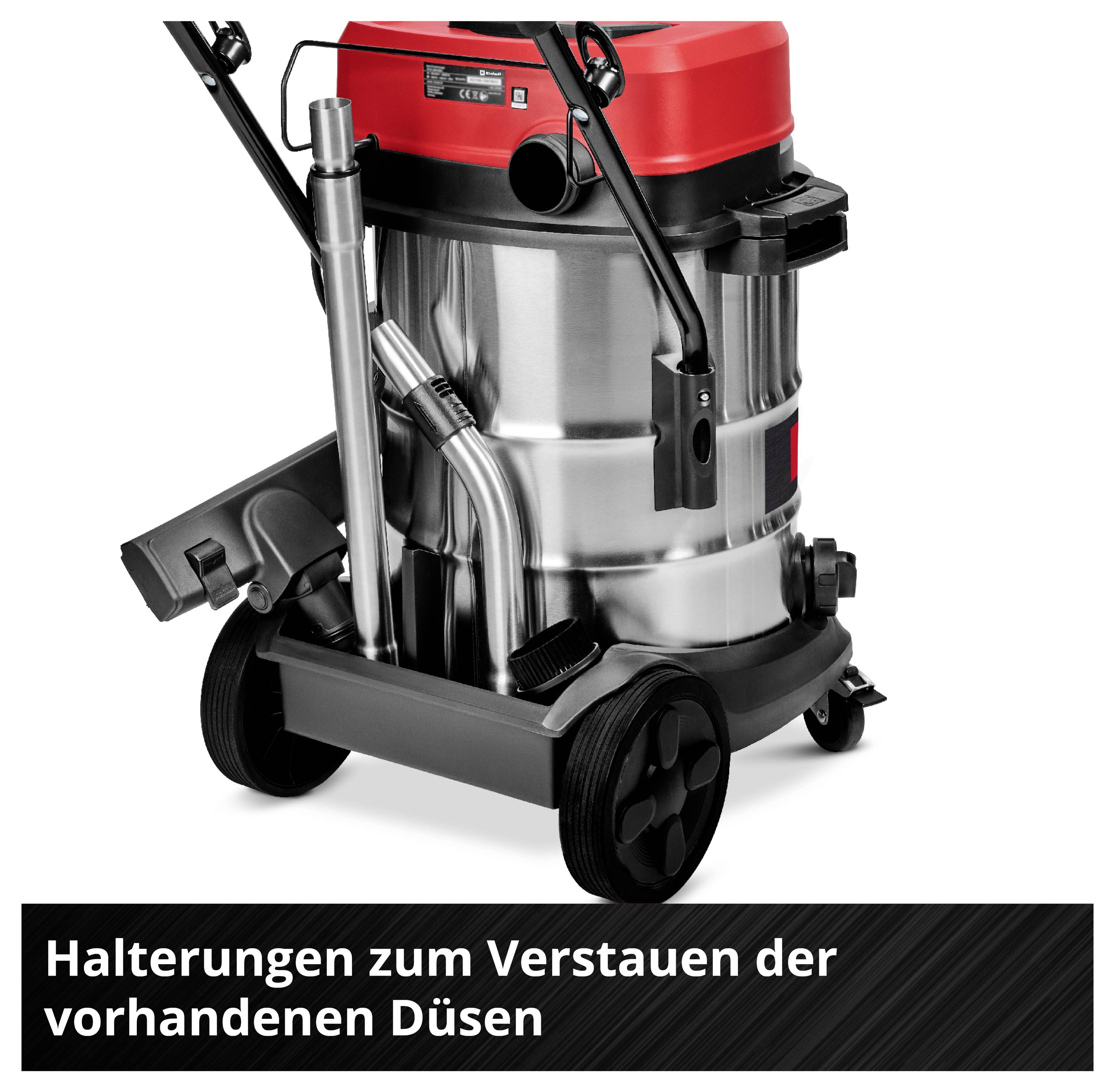Industriesauger auf Rädern mit rotem Deckel, Metallkorpus und montiertem Zubehör. Text: 'Halterungen zum Verstauen der vorhandenen Düsen'.