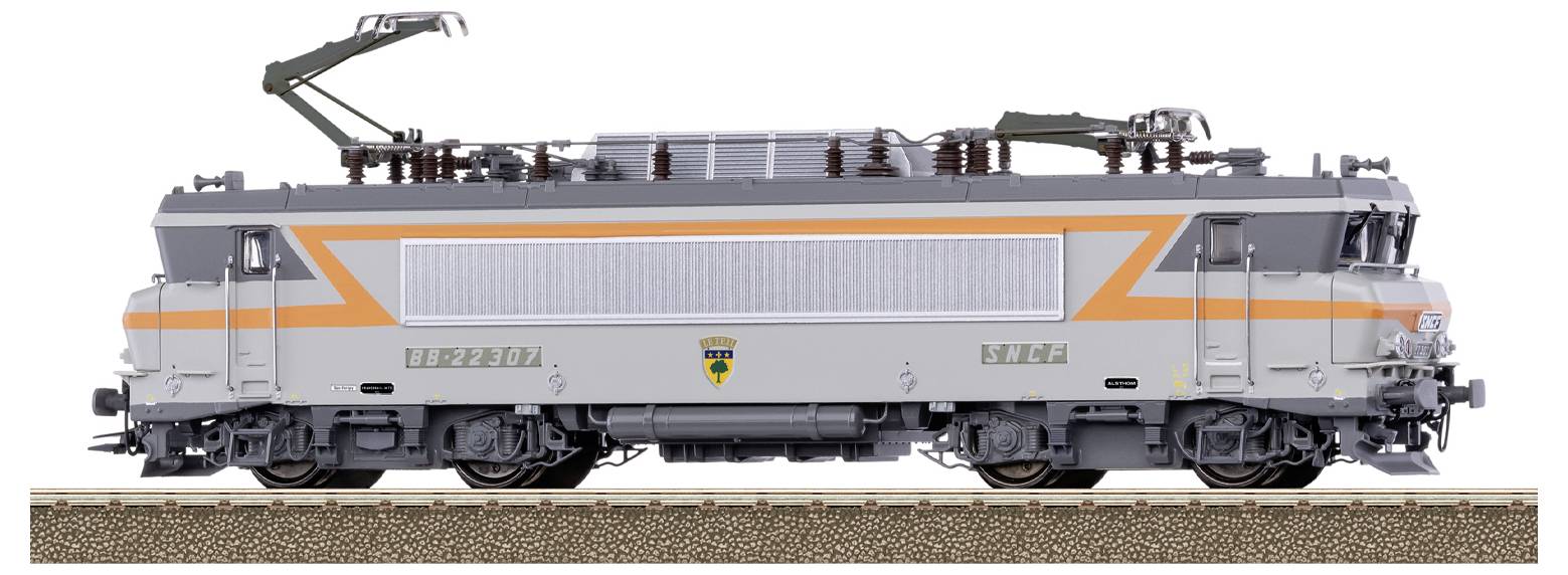Modelleisenbahn-Lokomotive mit grau-orangefarbener Gestaltung, französische SNCF-Markierung am Gehäuse sichtbar, auf einem kurzen Gleisabschnitt ausgestellt.