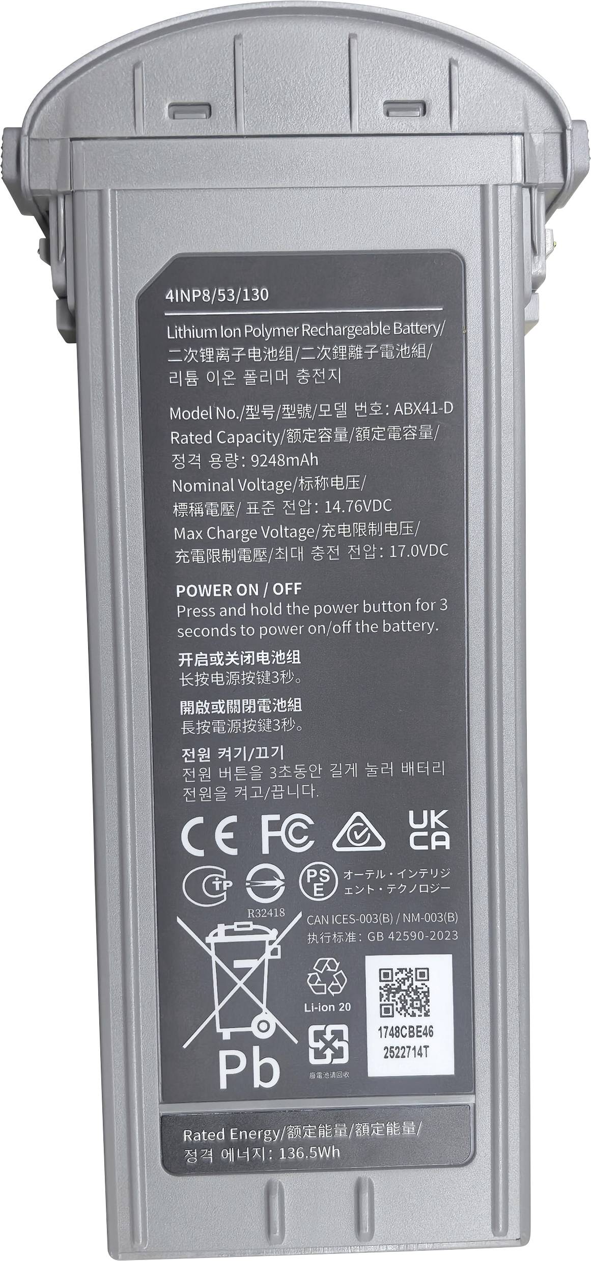 Ein rechteckiger Lithium-Polymer-Akku mit Etiketten, die technische Spezifikationen, Sicherheitssymbole und Bedienungshinweise für den Powerknopf aufweisen.