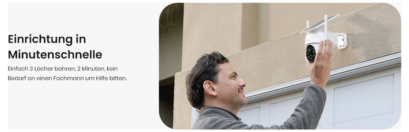 Ein Mann, der eine Sicherheitskamera an einer Wand neben einem Garagentor installiert. Text lautet: Einrichtung in Minutenschnelle. Einfach 3 Löcher bohren, 2 Minuten, kein Bedarf an einen Fachmann um Hilfe zu bitten.