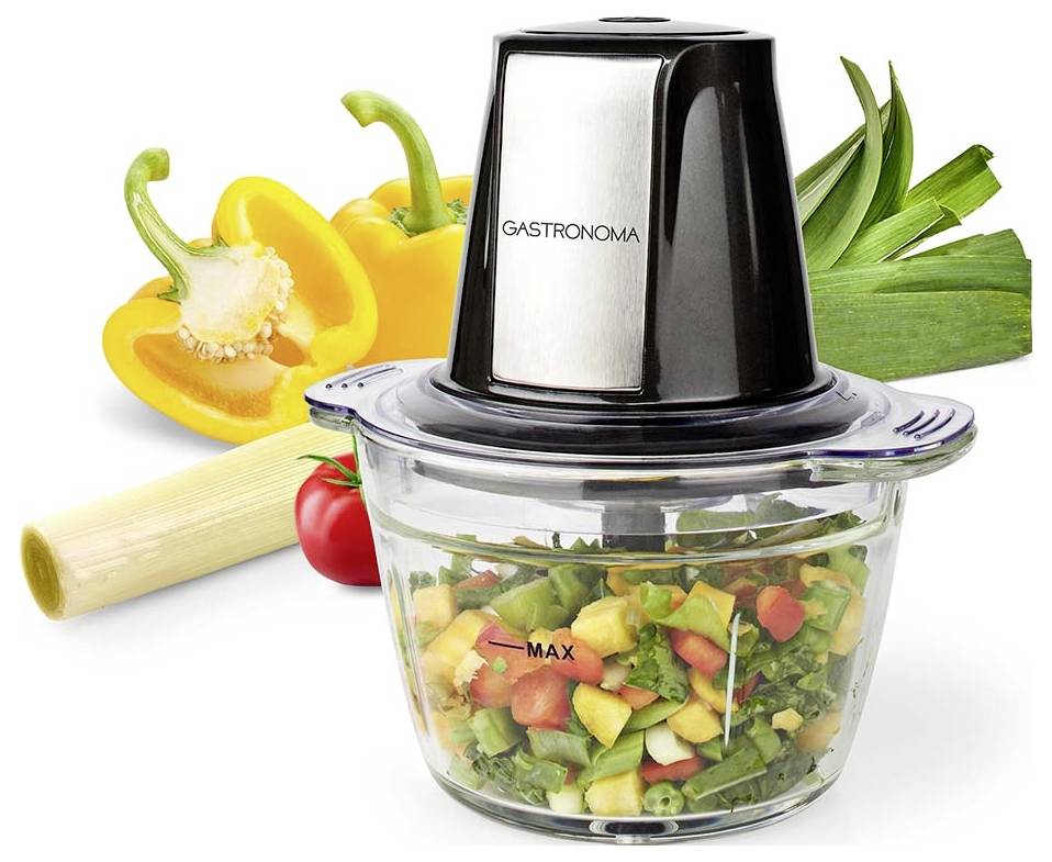 Ein Küchenmaschinencontainer mit gewürfeltem Gemüse wird neben gelber Paprika, Tomate und Lauch gezeigt; der Markenname lautet 