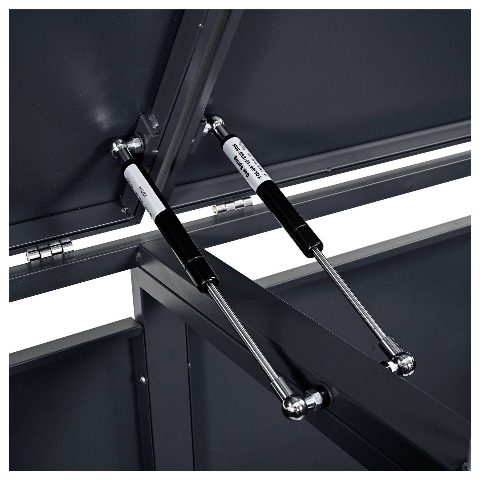 Nahaufnahme von hydraulischen Scharnieren, die an Metallpaneelen befestigt sind, möglicherweise Teil eines Lager- oder Zugangstürmechanismus.