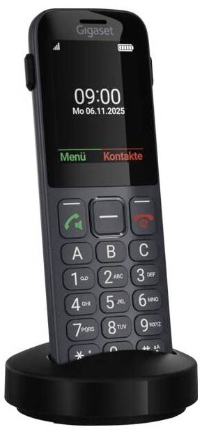 Ein schnurloses Telefon mit großen Tasten und einem Display, auf dem die Uhrzeit '09:00' und das Datum 'Mo 06.11.2025' angezeigt werden, das auf einer Ladestation steht.