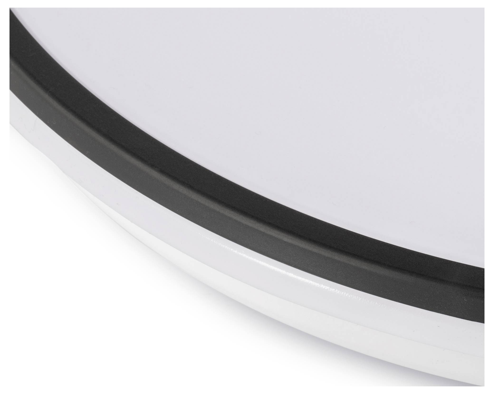 Nahaufnahme eines kreisförmigen Objekts mit weißer Oberfläche und schwarzem Rand, möglicherweise ein Teil eines größeren Gegenstands oder Geräts. Kein Text oder Kontext sichtbar.