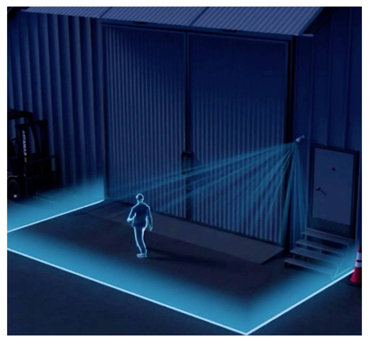 Eine Person geht bei Nacht auf ein großes Industrietor zu, beleuchtet von blauen Lichtern am Boden und einem Sicherheitslicht darüber.