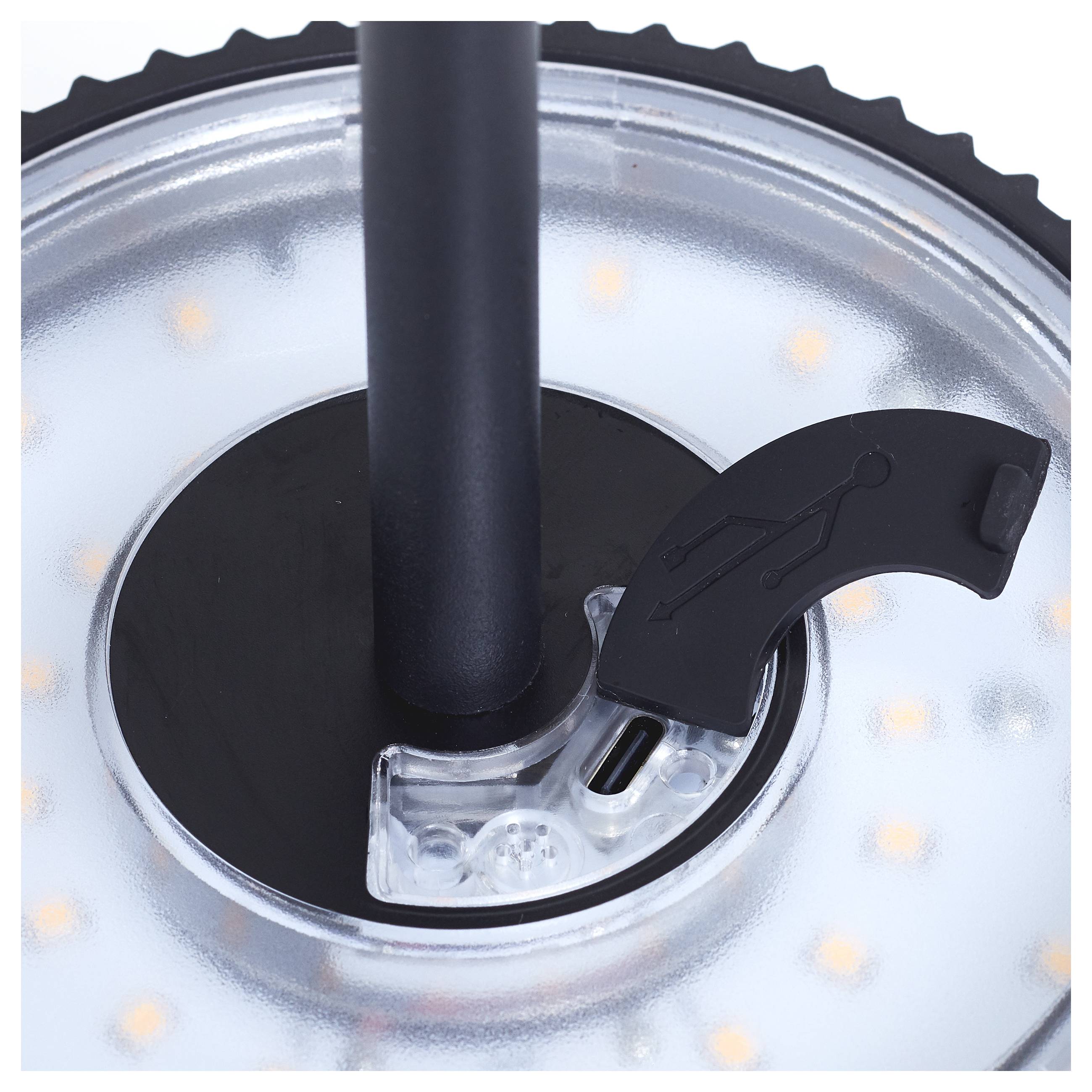 Nahaufnahme eines kreisförmigen LED-Lichtringes mit einer zentralen schwarzen Stange und einem kleinen schwarzen Griff, der ein Menschenfigur-Symbol trägt.