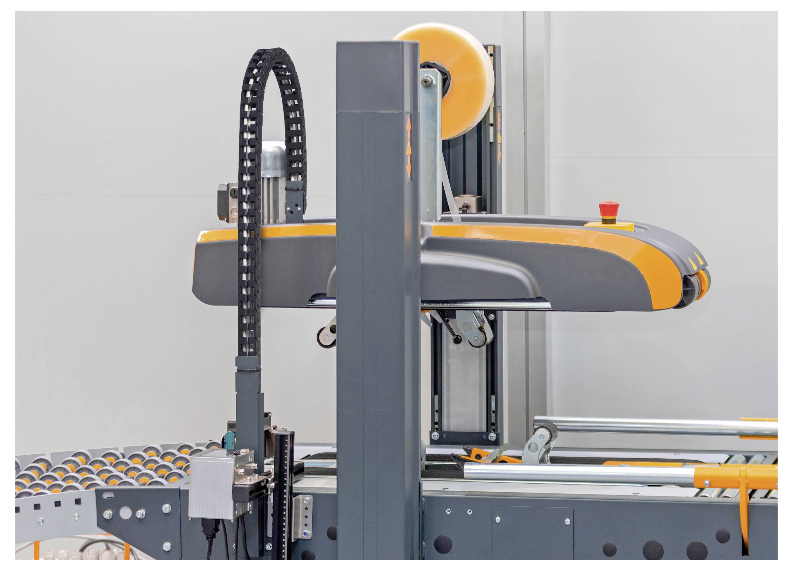 Eine moderne Verpackungsmaschine in einer Fabrikumgebung mit Walzen und automatisierten Komponenten, mit Schwerpunkt auf industrielle Effizienz.