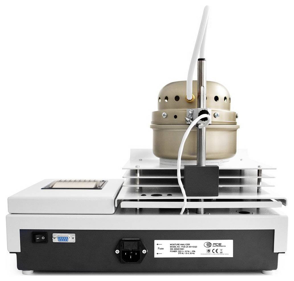 Laborinstrument mit einer beheizten Kammer und angeschlossenen Schläuchen auf einer Benchtop-Basis, wahrscheinlich für die Probenverarbeitung oder -analyse.