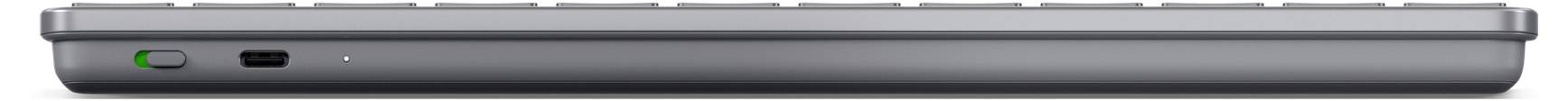 Ein Nahaufnahme einer geschlossenen, schlanken, dunkelgrauen Laptop von der vorderen Kante, die die Anschlüsse an der Seite hervorhebt.