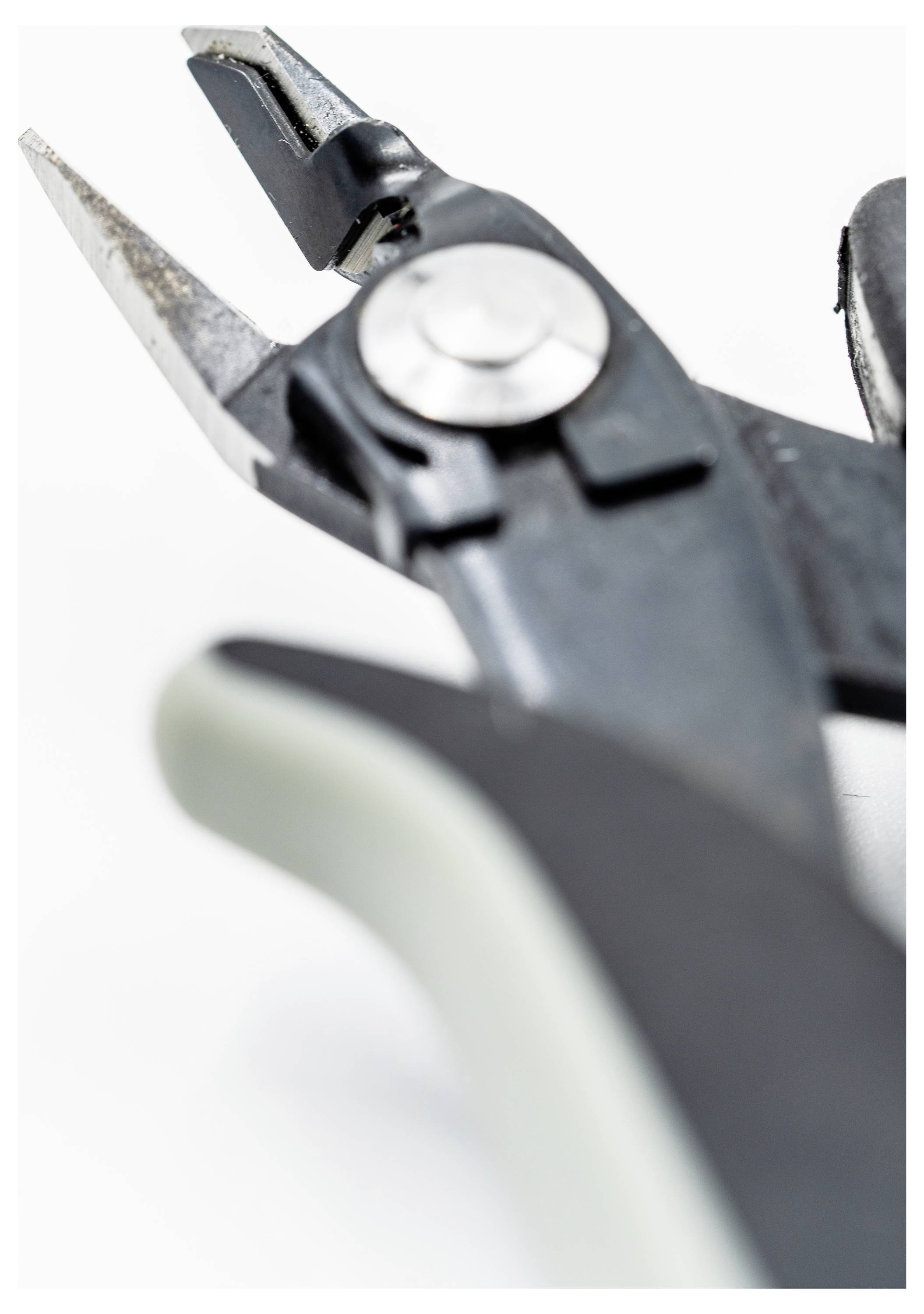 Nahaufnahme eines schwarzen Drahtschneiders mit glänzender Metallklinge, die Details des Drehmechanismus und des Griffgriffs auf weißem Hintergrund zeigt.