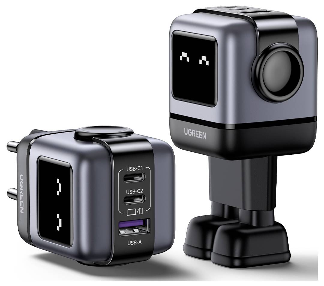 „Zwei schwarz-graue roboterförmige USB-Ladegeräte mit quadratischen Köpfen, eines eingesteckt, eines auf abnehmbaren Beinen stehend, beide mit digitalen Augen.
