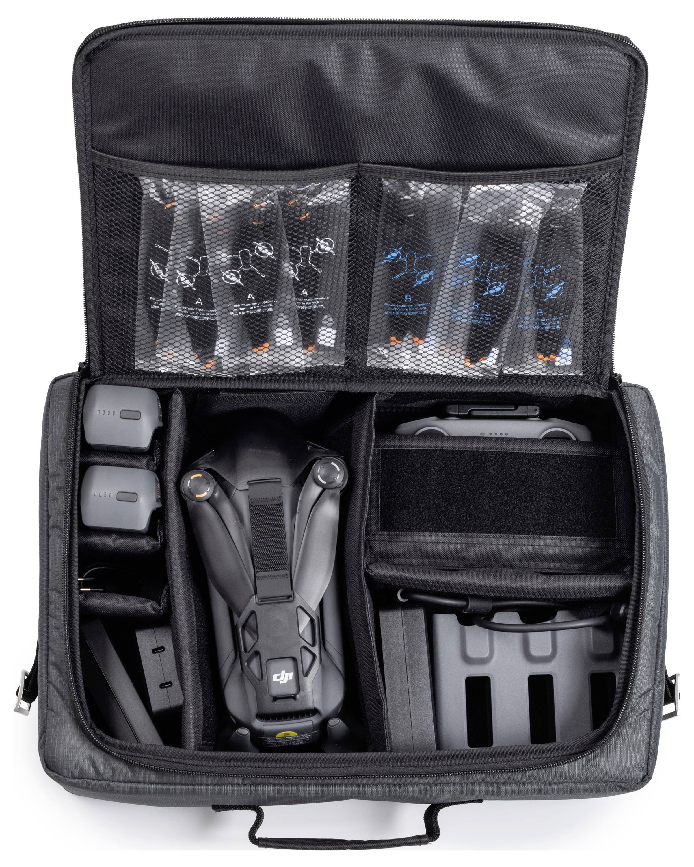 „Offener schwarzer Transportkoffer mit einer Drohne, Fernbedienung, Batterien und verschiedenen Zubehörteilen, die in Netztaschen und Fächern verstaut sind.