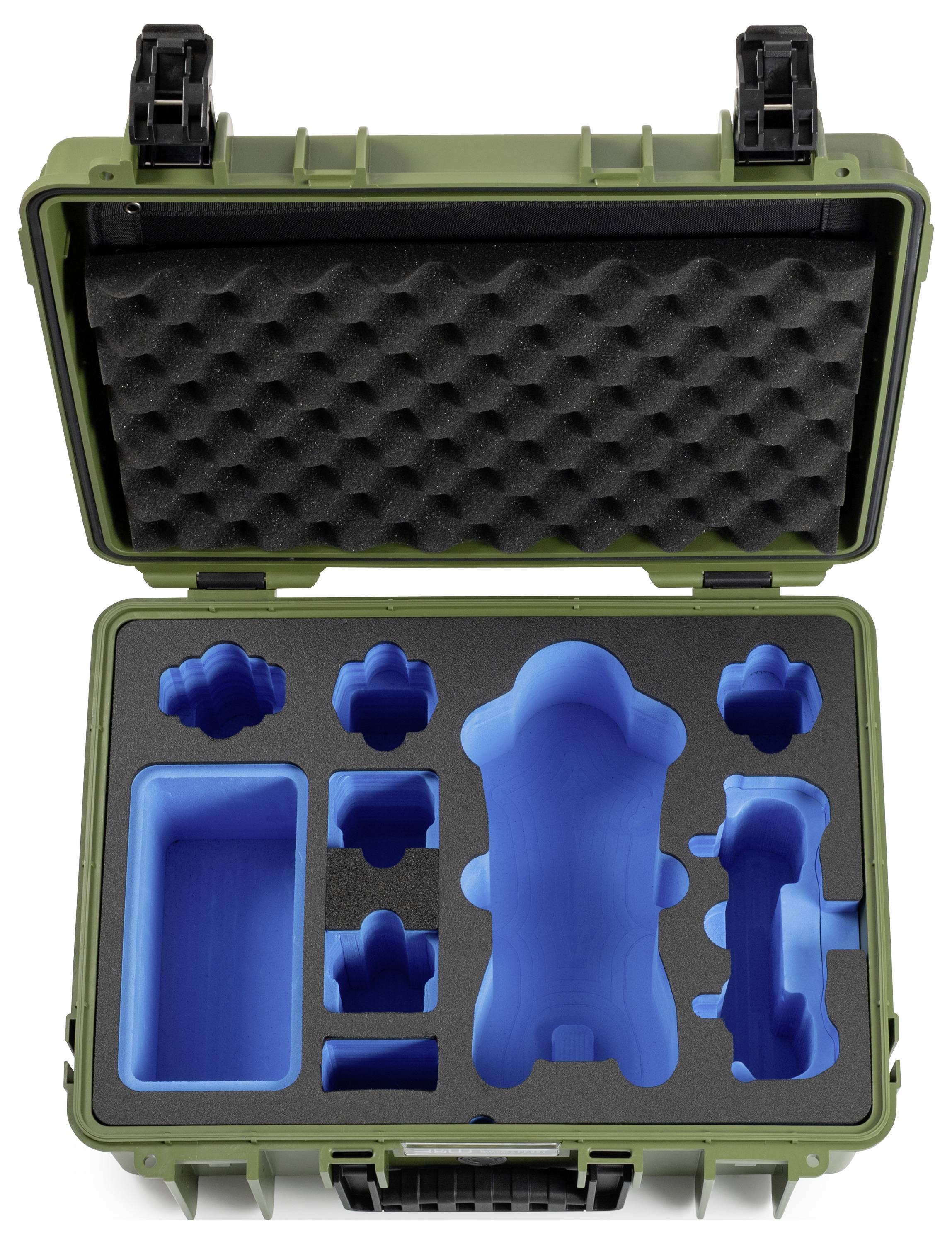 Ein offener grüner Koffer mit schützlichem schwarzem Schaumstoff mit mehreren blau geformten Vertiefungen zum Lagern verschiedener Gegenstände.