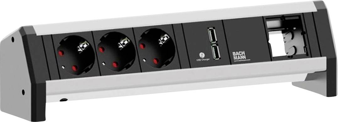 Eine horizontale Steckdosenleiste mit drei Steckdosen, zwei USB-Anschlüssen und einem offenen Modulfach, gekennzeichnet mit der Marke „BACHMANN