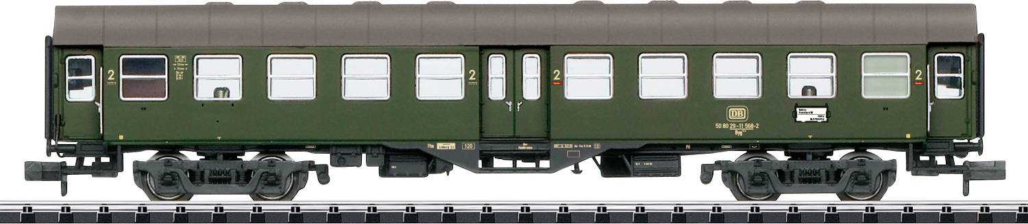 Ein Modell eines grünen Güterwagens mit detaillierten Fenstern und Rädern auf einer Anzeigestrecke, das klassisches Schienendesign zeigt.