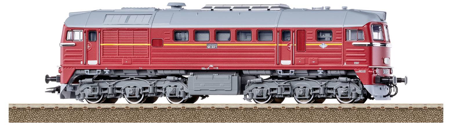 Ein Modelzug mit blau-weißer Lackierung auf einem Gleis durch bewachsenes Gelände. Der Zug ist mit „DB