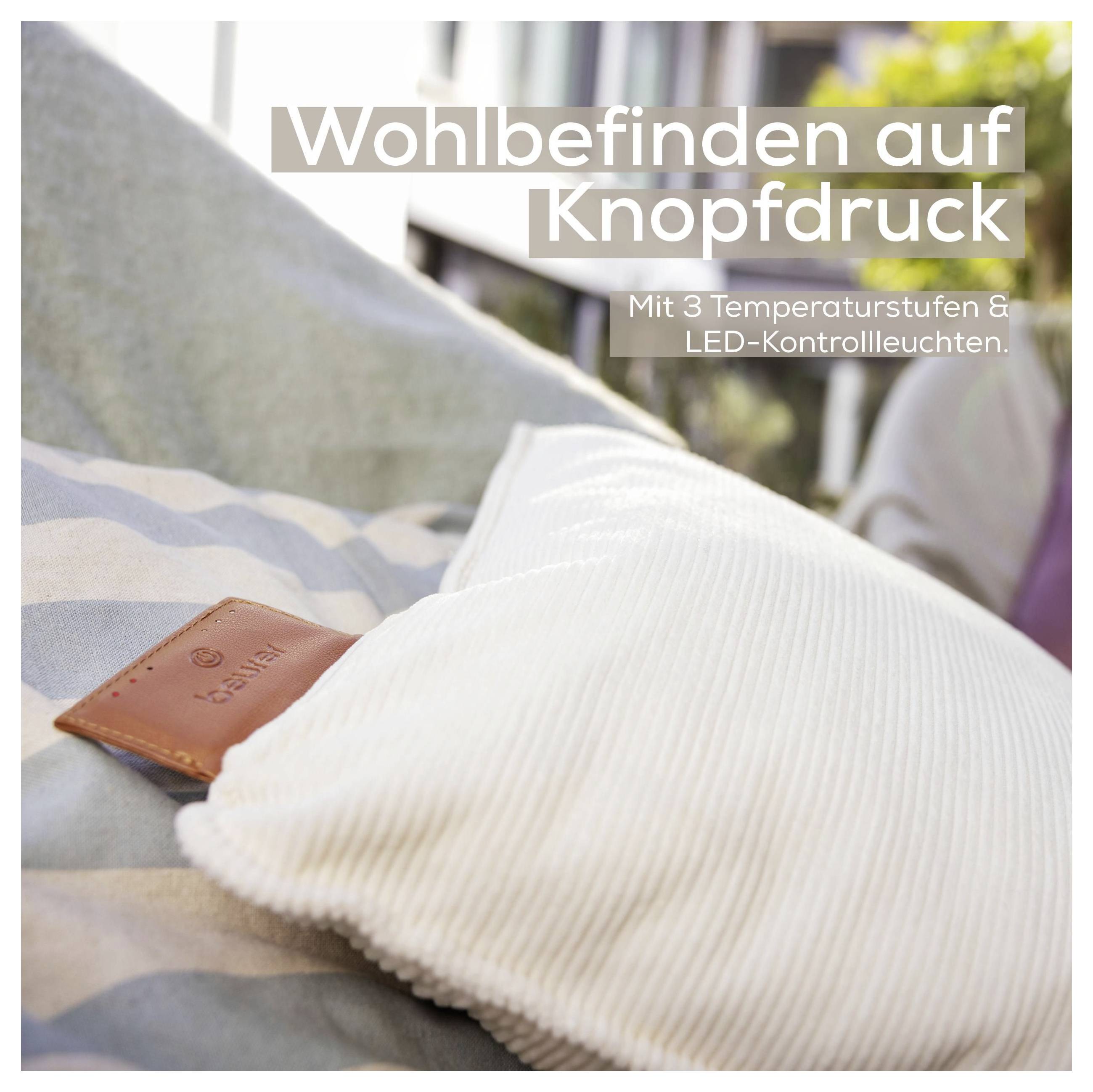 Ein Gefühl von Wohlbefinden auf Knopfdruck. Mit 3 Temperaturstufen & LED-Kontrollleuchten.' Weißes Kissen auf gestreiftem Stoff.
