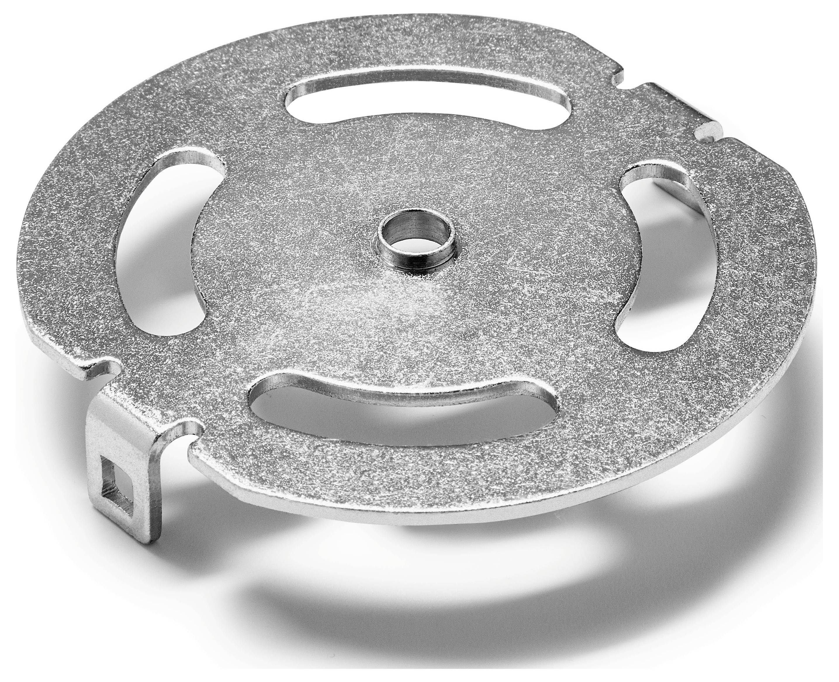 Ein rundes Metallobjekt mit einem offenen zentralen Loch und vier gekrümmten Ausschnitten, möglicherweise ein Teil einer mechanischen oder industriellen Komponente.