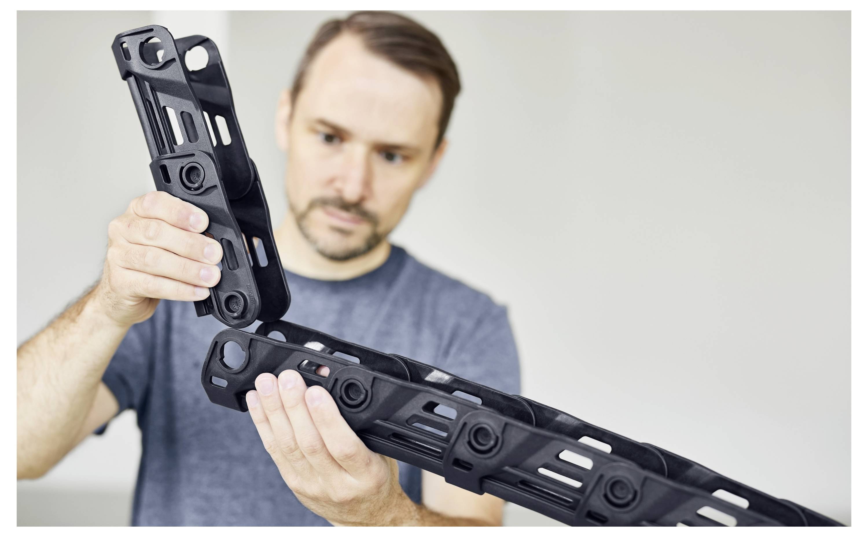 Arbeiter, der ein Elektrowerkzeug verwendet, um eine Betonfläche zu schleifen oder zu schleifen, und dabei Schutzausrüstung trägt.