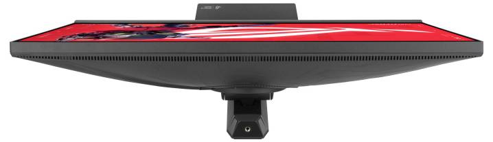 „Draufsicht auf einen Flachbildschirm-Monitor mit lebendiger roter Kunstwerk-Anzeige mit abstrakten Formen, montiert auf einem einzigen schwarzen Ständer.