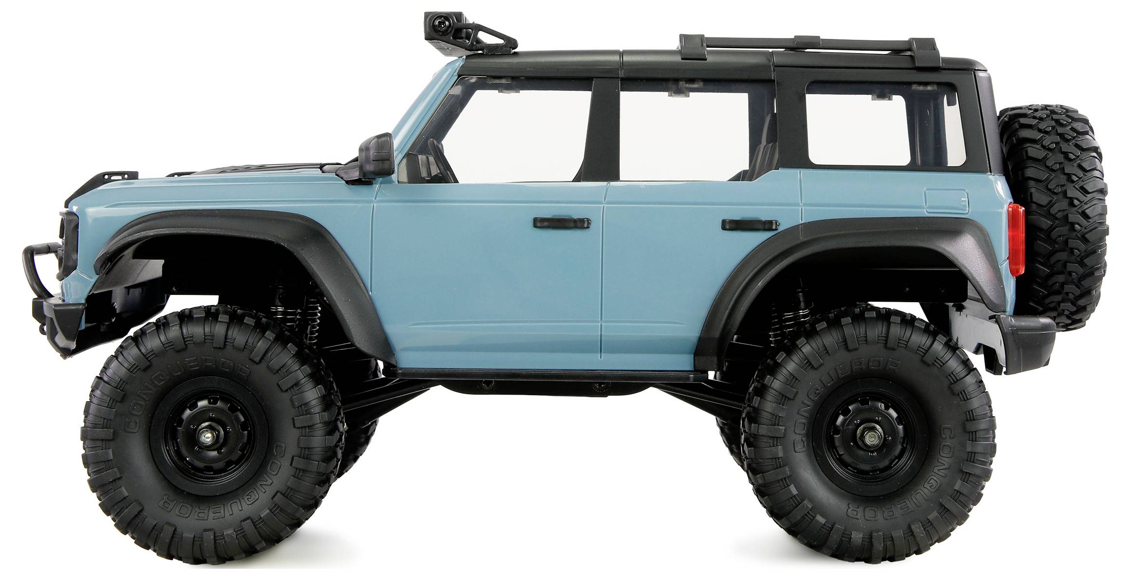 Ein blaues Geländefahrzeug mit großen Reifen und Dachgepäckträger, von der Seite betrachtet.