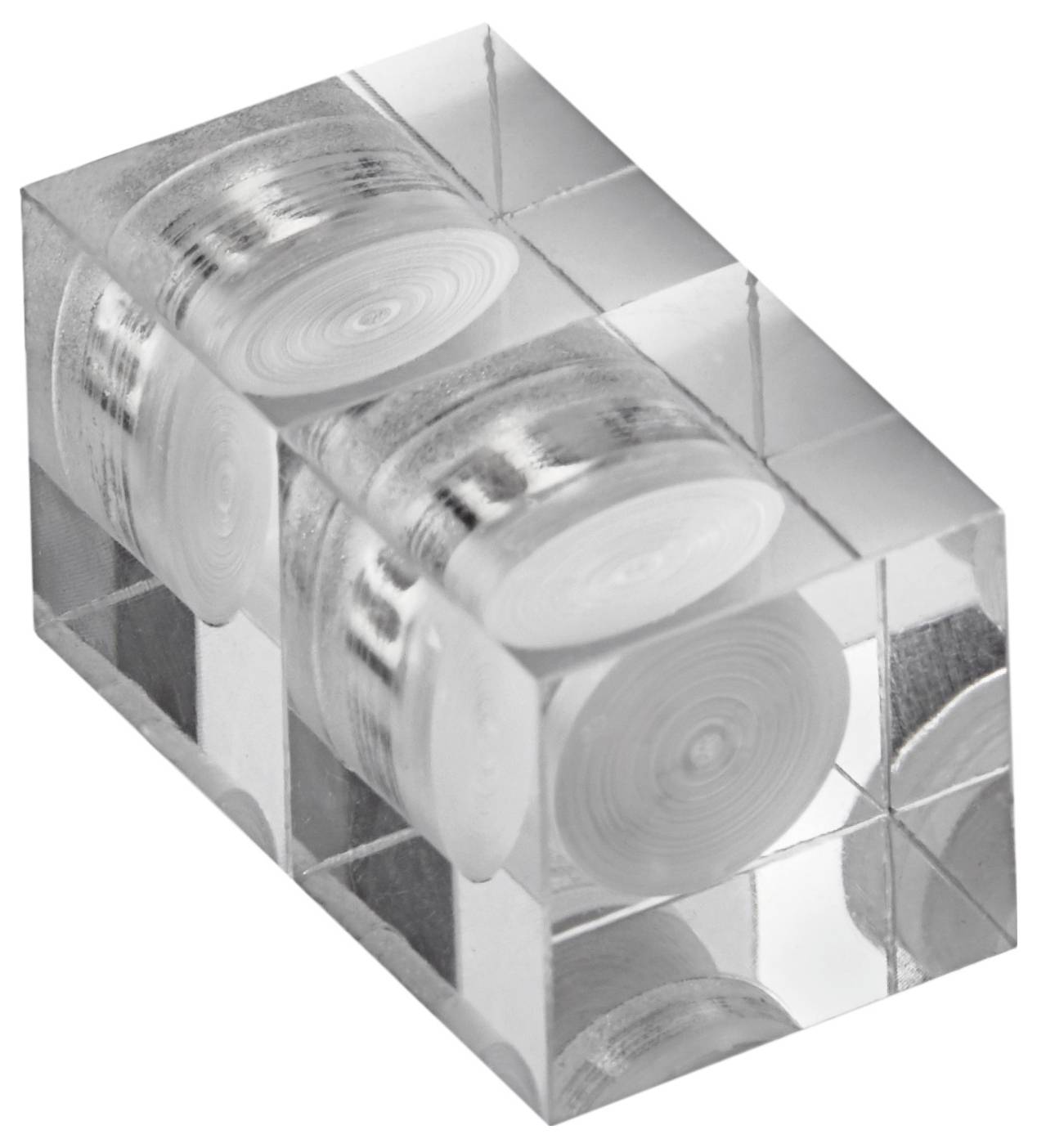 Ein transparenter Block, der mehrere aufgerollte Filmrollen enthält, die symmetrisch angeordnet sind und eine einzigartige künstlerische Präsentation zeigen.