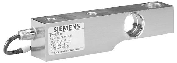 Eine zylindrische Metallkomponente mit zwei quadratischen Enden und schwarzen ovalen Ausschnitten auf jeder Seite, mit der Kennzeichnung „SIEMENS